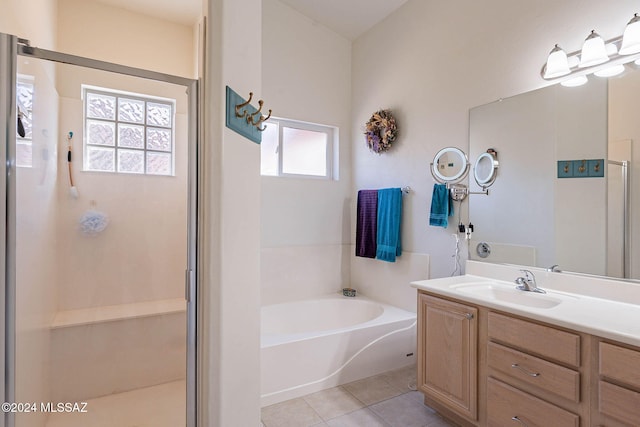 bathroom featuring a bath, a shower stall, tile patterned flooring, and vanity