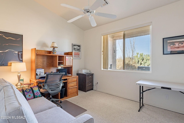 office featuring vaulted ceiling, a ceiling fan, visible vents, and light colored carpet