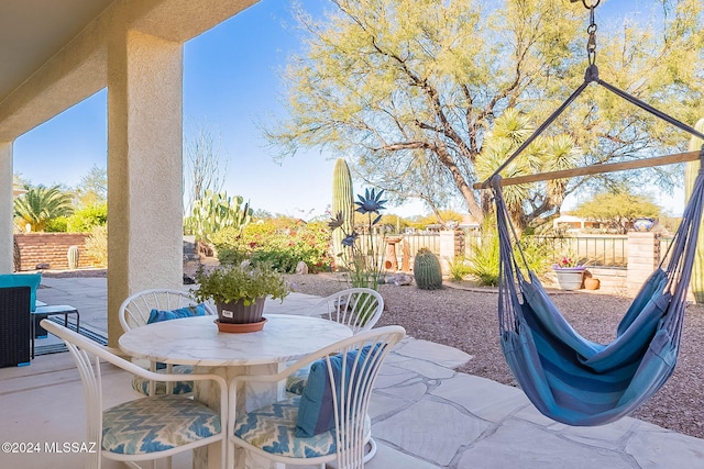 view of patio with outdoor dining area and fence