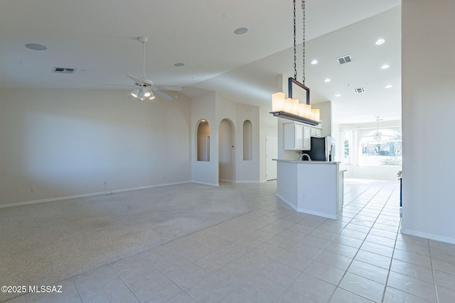 kitchen with a ceiling fan, open floor plan, and visible vents