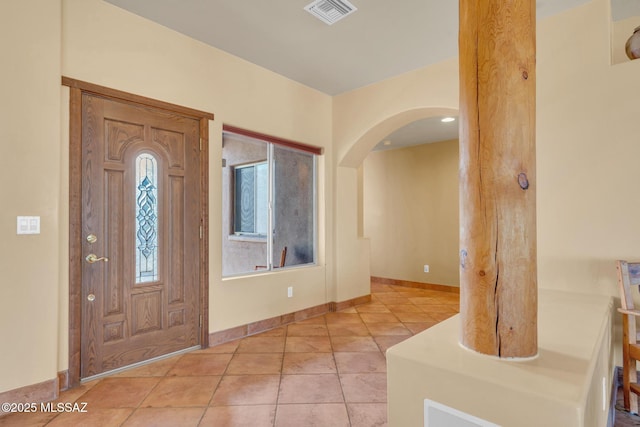 foyer entrance with light tile patterned flooring and plenty of natural light