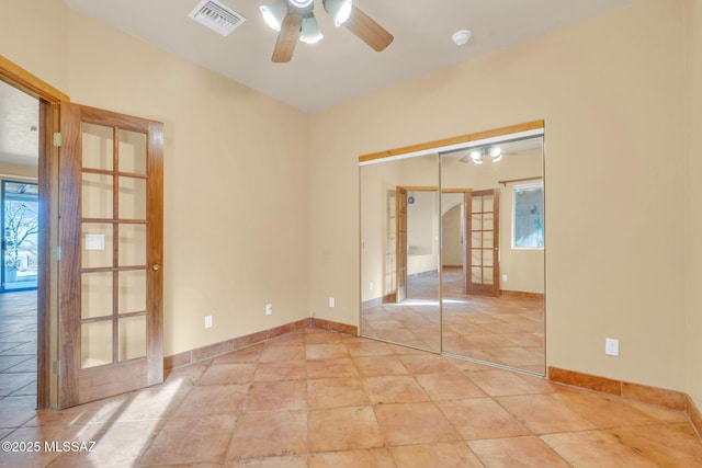 unfurnished room featuring light tile patterned floors, french doors, and ceiling fan