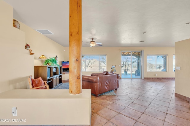 living room with ceiling fan, a healthy amount of sunlight, and light tile patterned floors