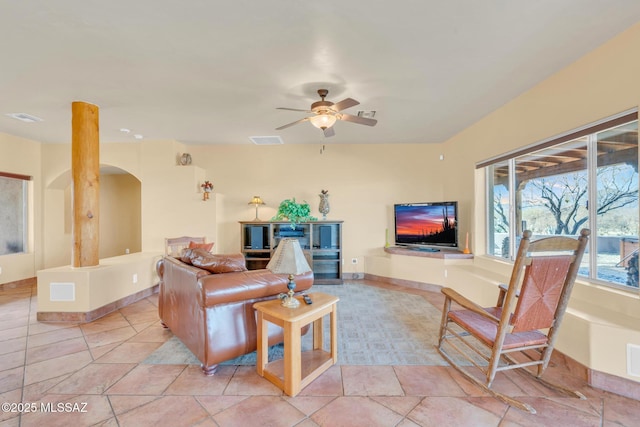 living room featuring light tile patterned floors and ceiling fan