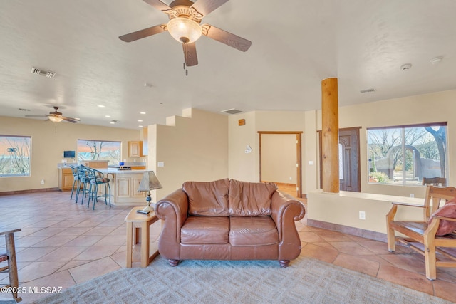 tiled living room featuring ceiling fan