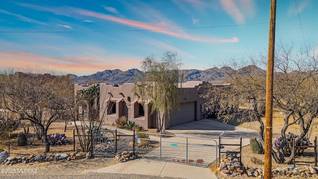 southwest-style home featuring a garage and a mountain view