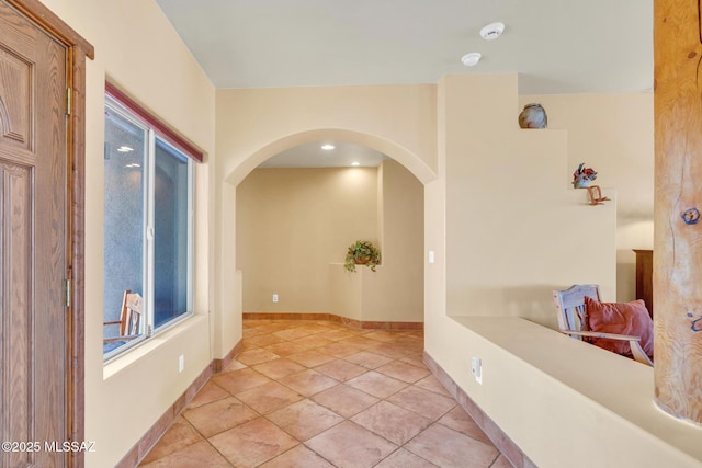 hall featuring light tile patterned floors