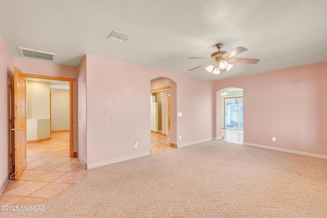 unfurnished room with ceiling fan and light tile patterned floors