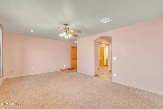 carpeted empty room featuring ceiling fan