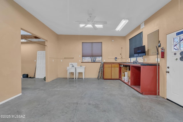 interior space featuring concrete flooring and ceiling fan