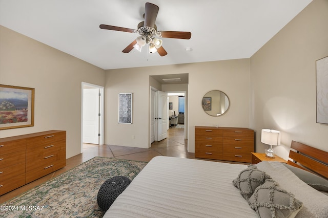 bedroom with ceiling fan and light tile patterned flooring