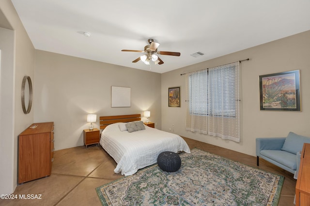 tiled bedroom featuring ceiling fan