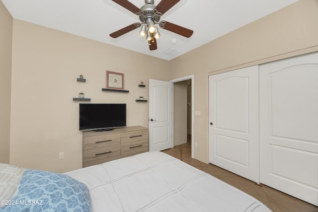 tiled bedroom with a closet and ceiling fan