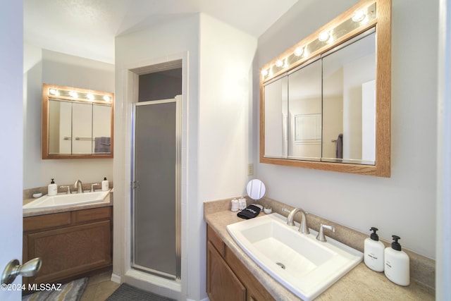 bathroom with vanity and a shower with door