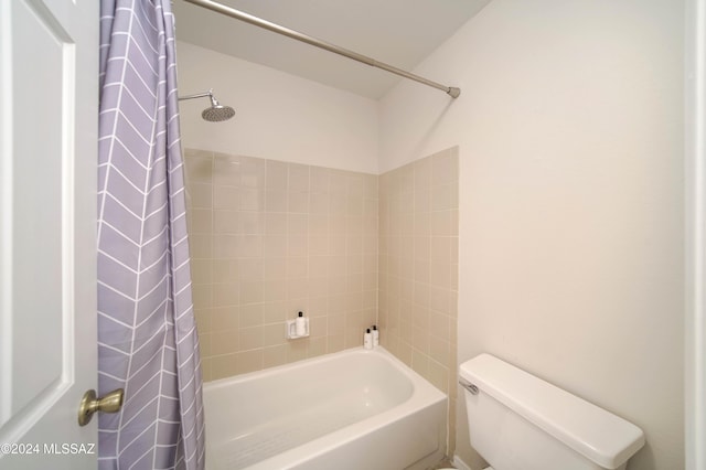 bathroom with toilet and shower / tub combo with curtain