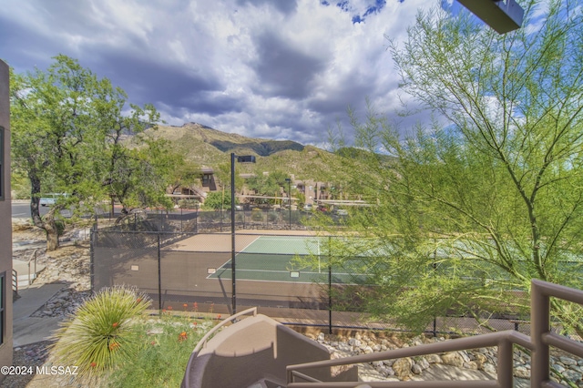 view of tennis court with a mountain view