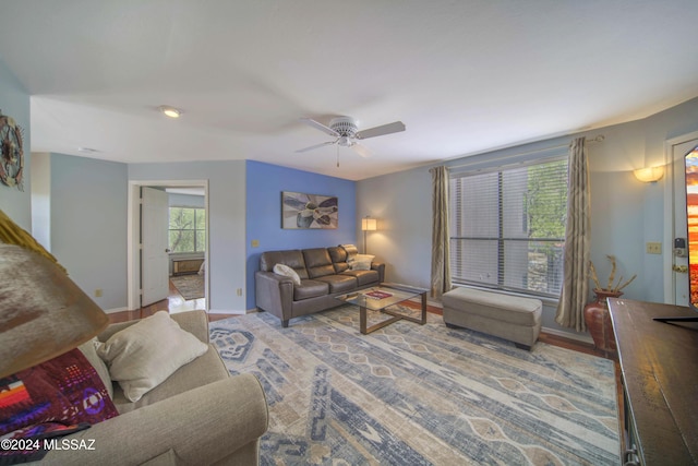 living room with light wood-type flooring and ceiling fan