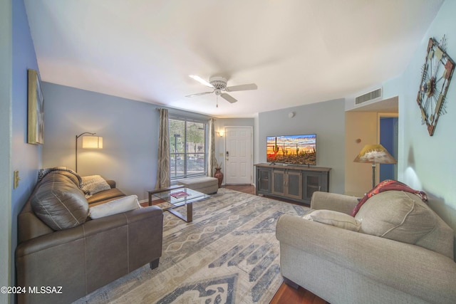 living room featuring hardwood / wood-style floors and ceiling fan