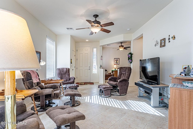 tiled living room with ceiling fan