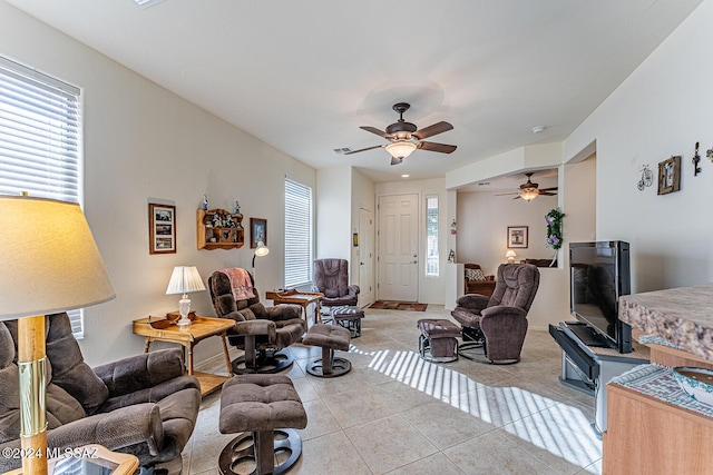 living room with light tile patterned floors and ceiling fan