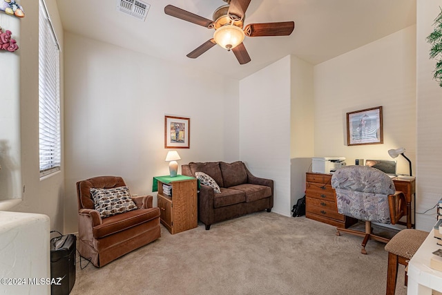 interior space featuring ceiling fan and light colored carpet