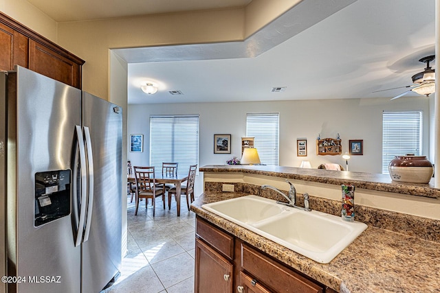 kitchen featuring ceiling fan, sink, light tile patterned flooring, and stainless steel refrigerator with ice dispenser