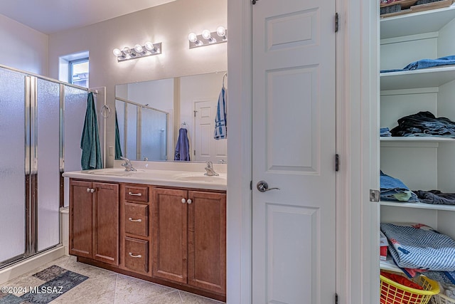 bathroom with tile patterned flooring, vanity, and a shower with shower door