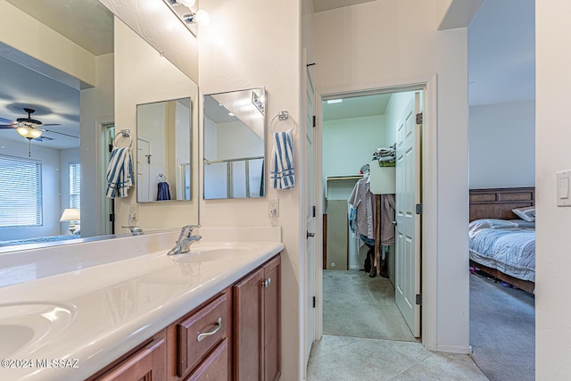 bathroom with tile patterned flooring, ceiling fan, and vanity