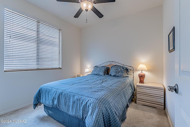 bedroom featuring ceiling fan and light carpet