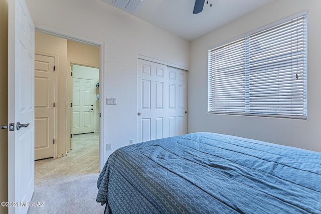 bedroom with ceiling fan, a closet, and light tile patterned flooring