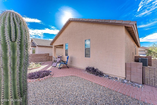 back of property with a patio and central AC unit