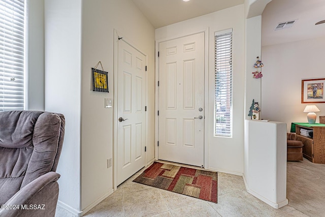 tiled foyer with a healthy amount of sunlight