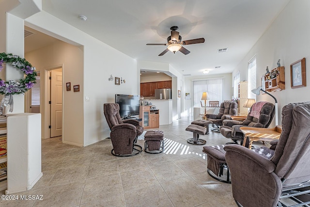 tiled living room featuring ceiling fan