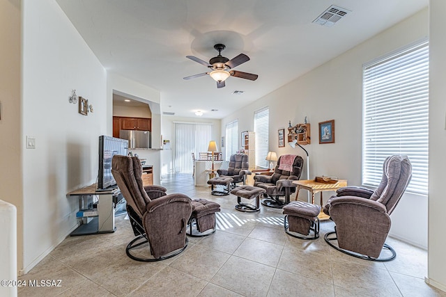 tiled living room featuring ceiling fan