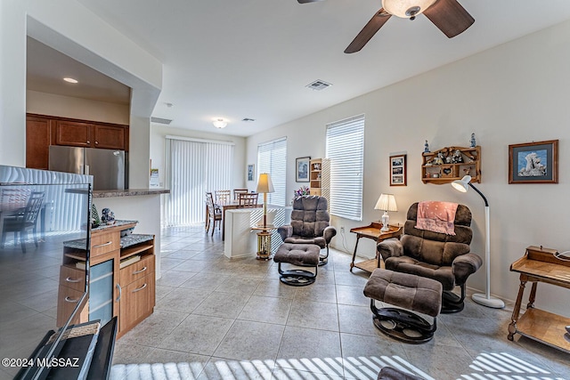 tiled living room featuring ceiling fan