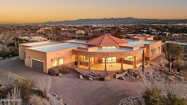 aerial view at dusk featuring a mountain view