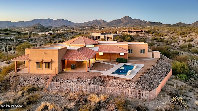 rear view of property with a patio area, central AC, and a mountain view