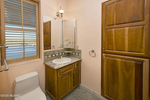 bathroom with toilet and vanity