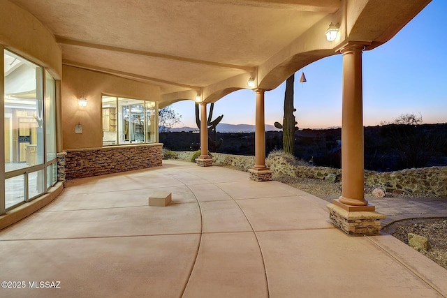 view of patio terrace at dusk