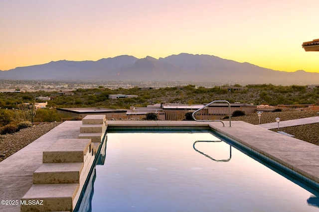 pool at dusk with a mountain view