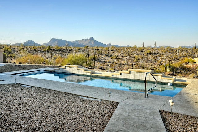 view of swimming pool with a mountain view