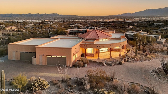 aerial view at dusk featuring a mountain view