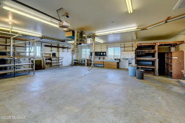 garage featuring a workshop area and a garage door opener