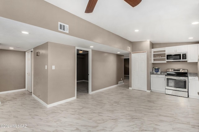 kitchen featuring white cabinetry, lofted ceiling, ceiling fan, stainless steel appliances, and light stone countertops