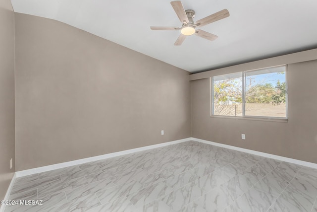 spare room featuring vaulted ceiling and ceiling fan