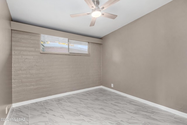 empty room with brick wall and ceiling fan