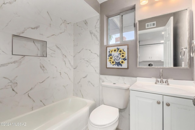 full bathroom featuring tiled shower / bath combo, vanity, and toilet