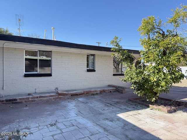 view of property exterior with a patio