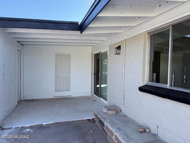 doorway to property featuring sink and a patio area