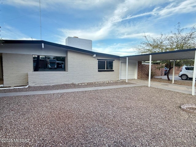 view of property exterior featuring a carport and a garage